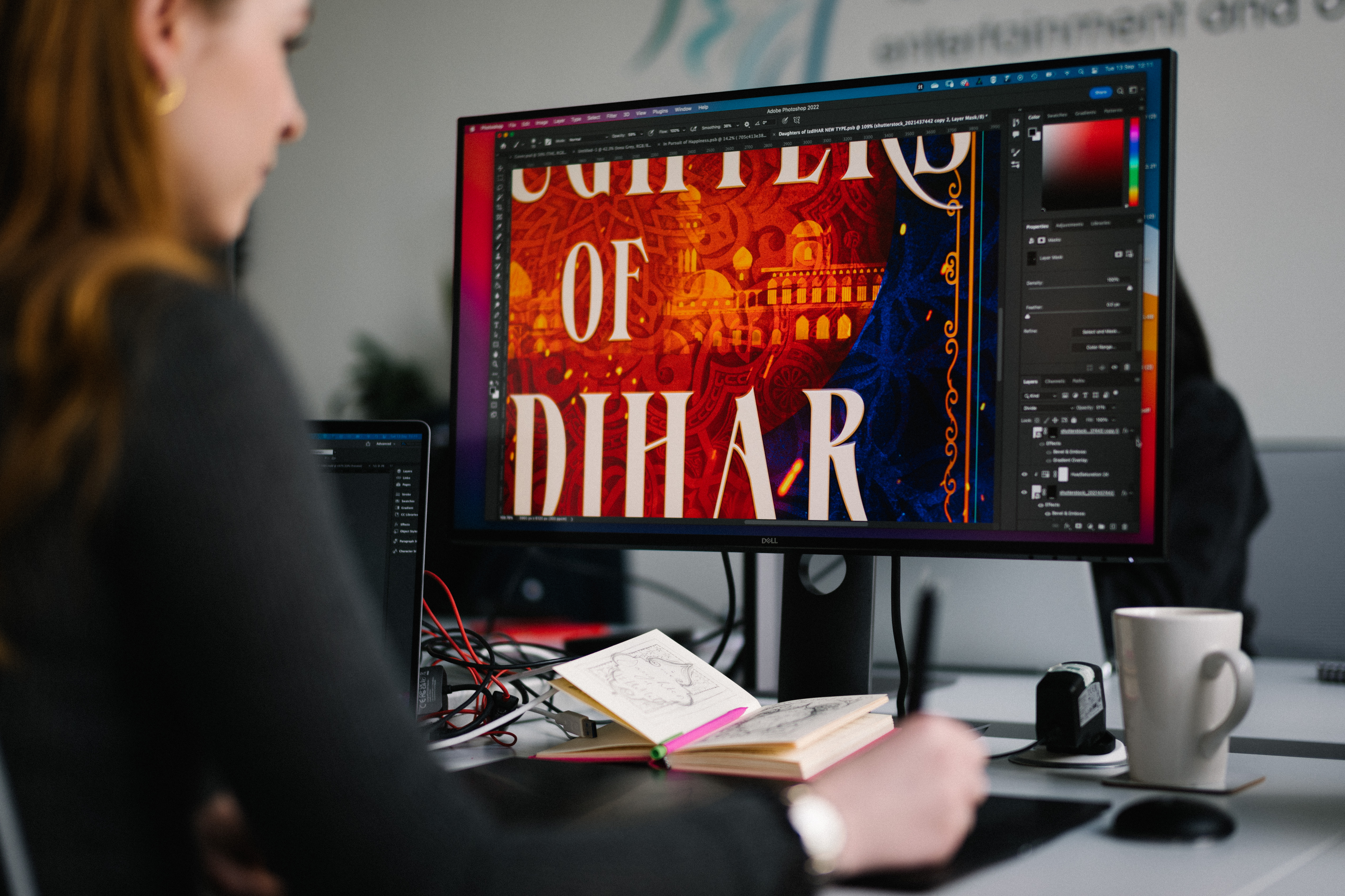 Image of someone in front of a screen working on a book cover design